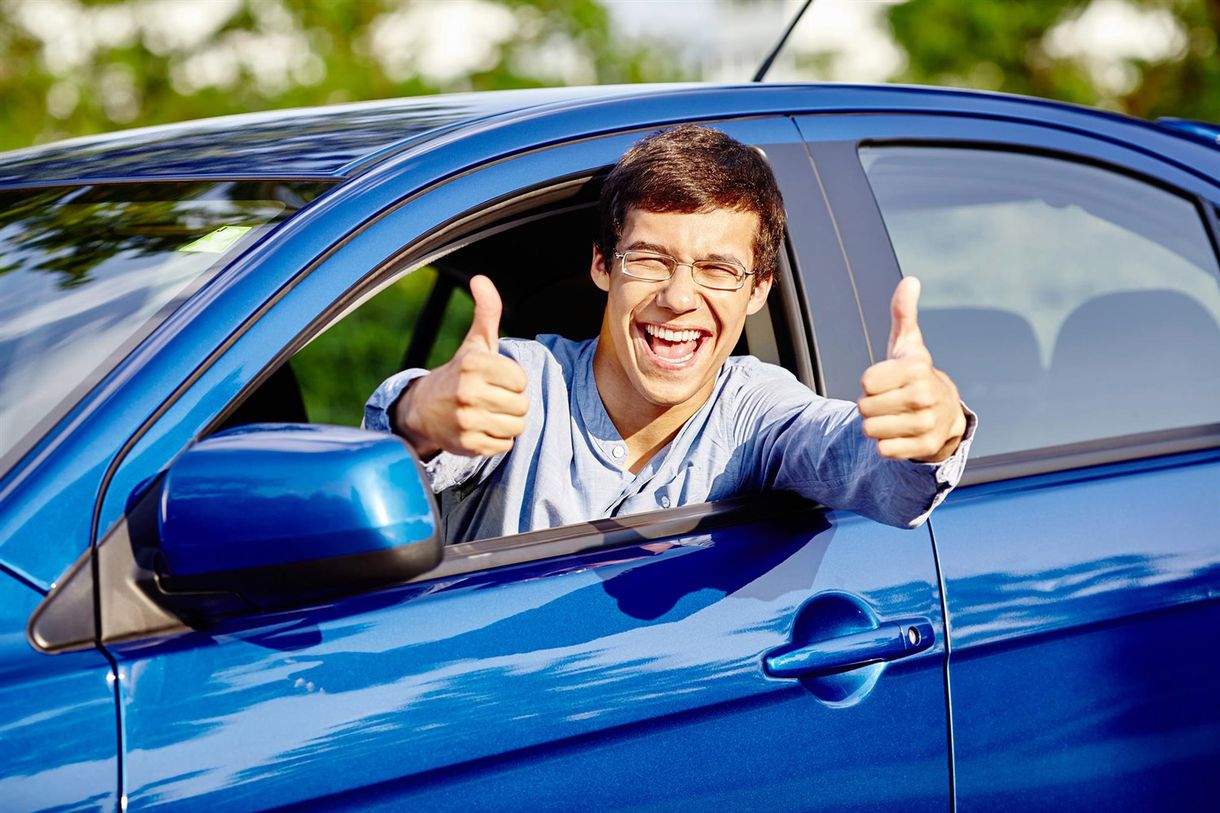 A young adult celebrates passing their driving test