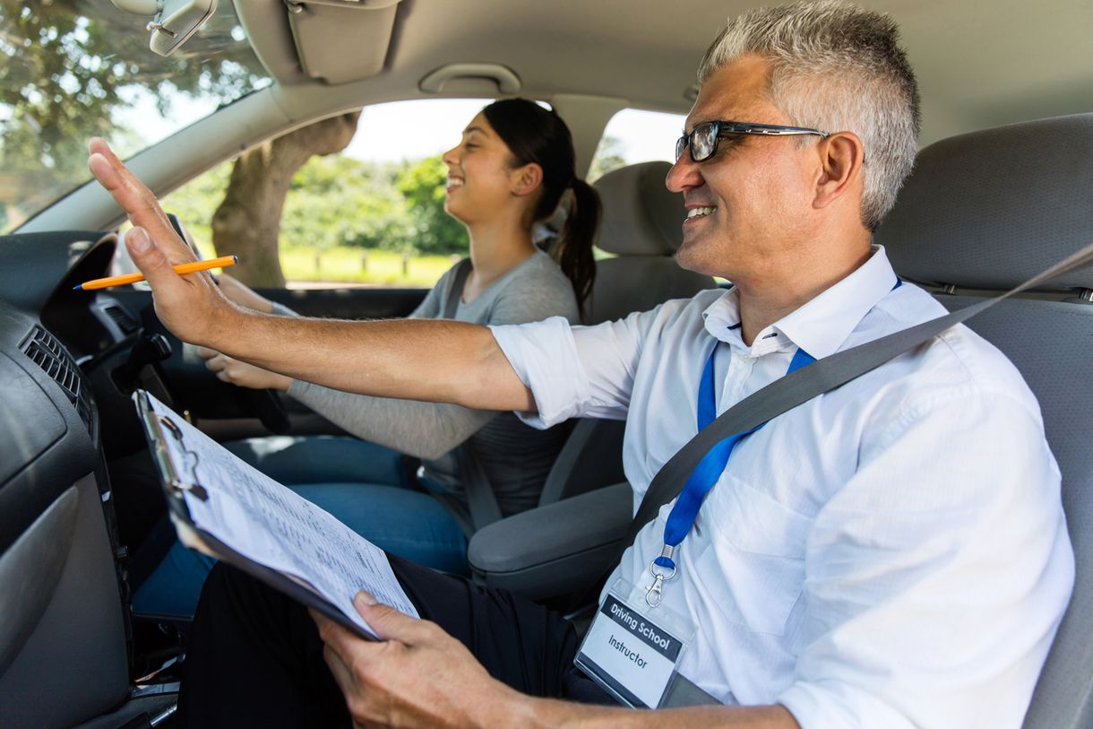 A instructor giving pointer to a learner driver